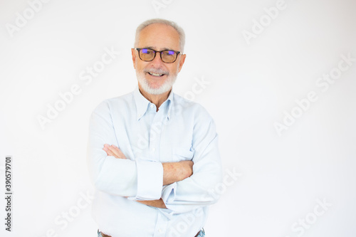 Portrait of cheerful senior man who is looking at camera and smiling over white background. © Danko