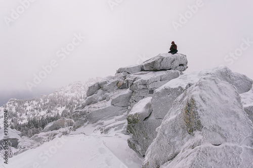 Hiking in the mountains through a snowy forest