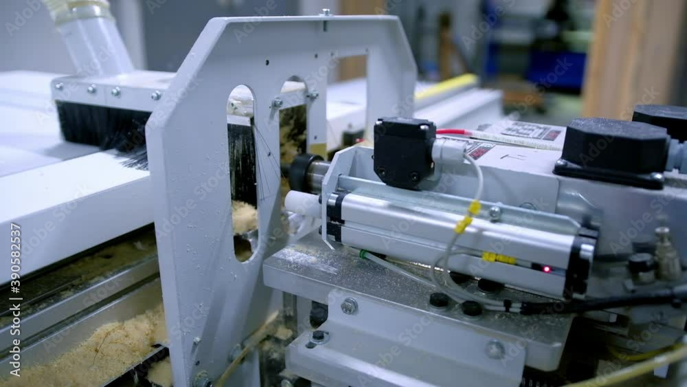 Automated machine in workshop. Manufacturing of doors. Work of modern instrument. Making furniture. Close-up.