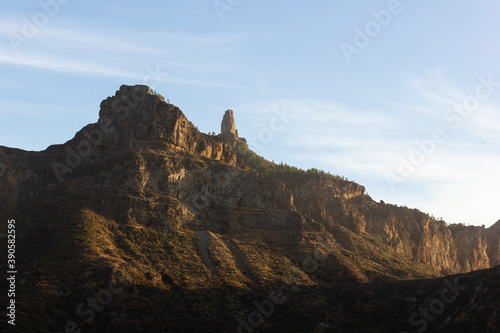 Sunset light on valley with Roque Nublo mountain on top in Gran Canaria  Spain. Natural landscape at twilight in Canary Islands. Tourist attraction destination concept