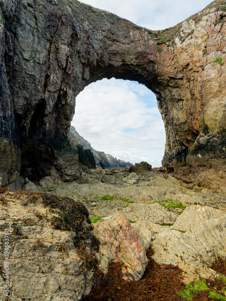 Sea arch at Pointe de Dinan on a cloudy day in summer