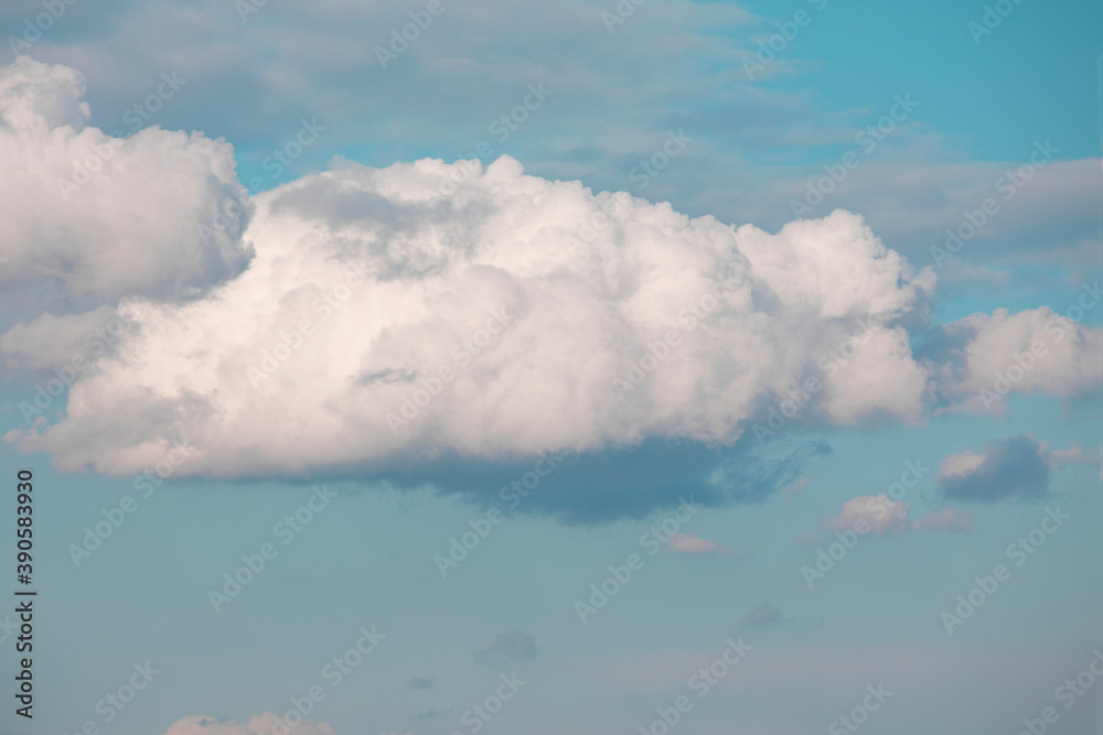 Big white fluffy clouds in blue sky. Summer background. Perspective. Big white fluffy clouds in blue sky. Summer background. Perspective.