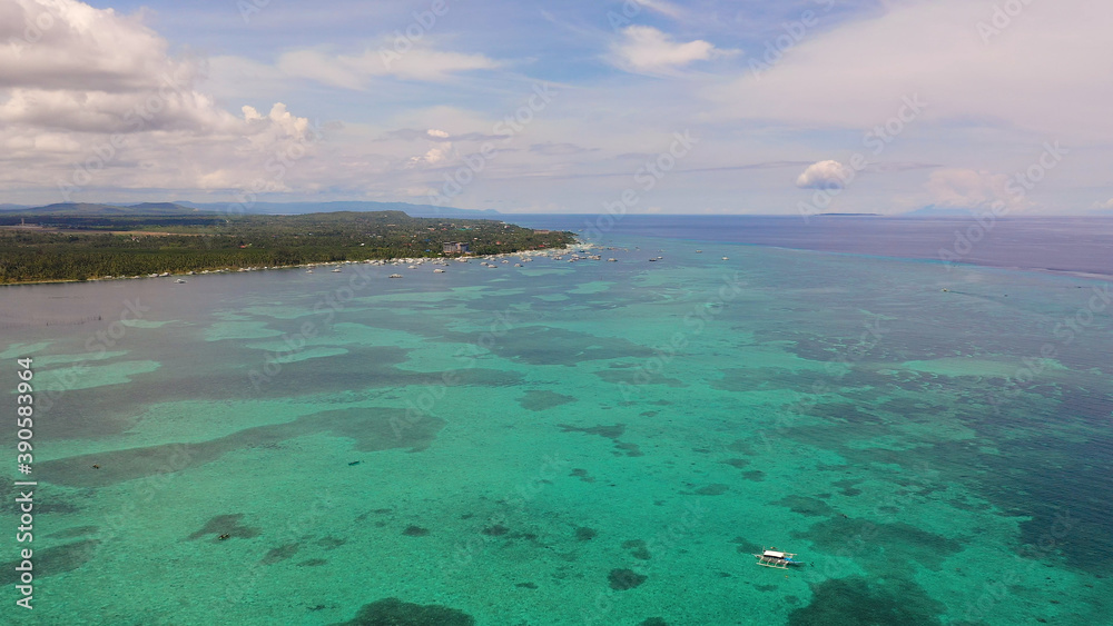 Fototapeta premium Tropical landscape: island with beautiful beach, palm trees by turquoise water. Panglao island, Alona beach, Philippines. Summer and travel vacation concept.