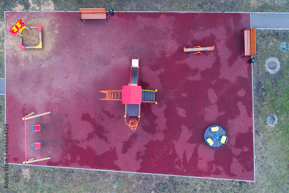 Top view of a playground with a slide and a swing.