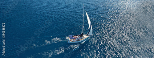 Aerial drone ultra wide photo of beautiful sailboat sailing in tropical exotic bay with emerald clear sea © aerial-drone