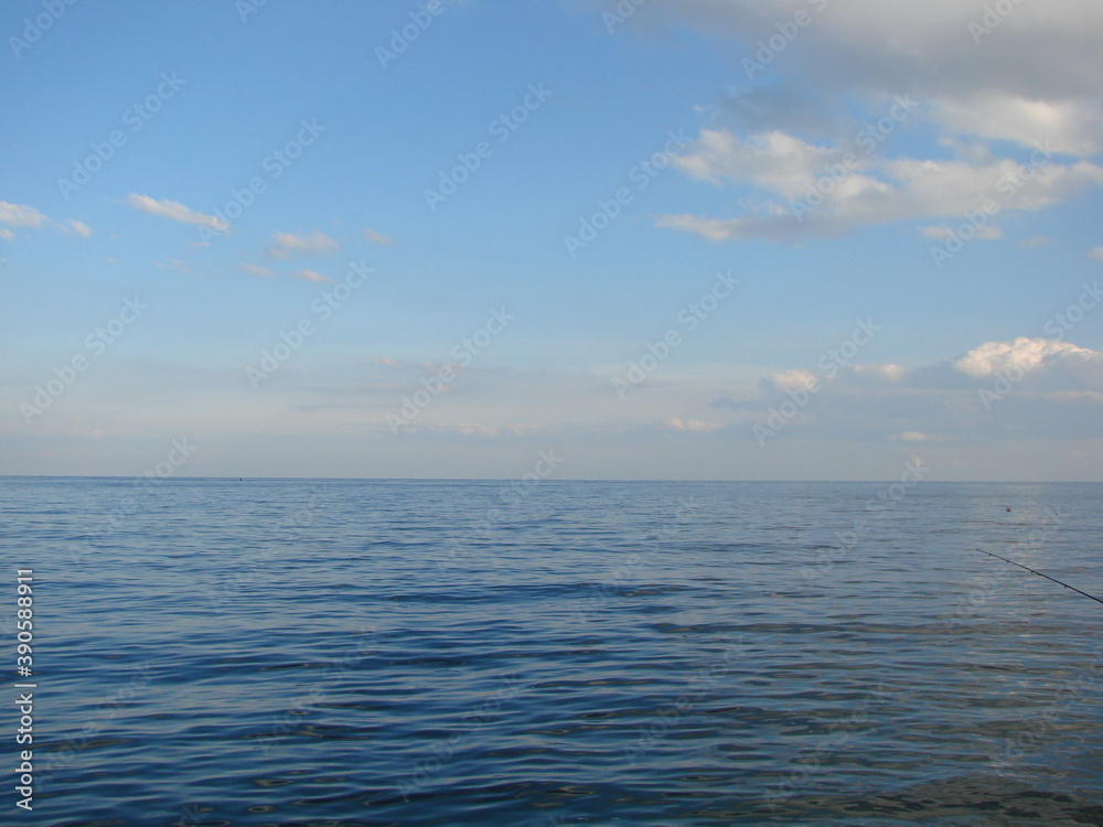 Panorama of the Black Sea coast in a windless evening at sunset.