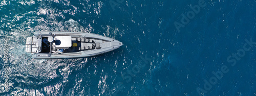 Aerial drone ultra wide photo of luxury inflatable speed boat cruising deep blue Aegean sea, Greece © aerial-drone