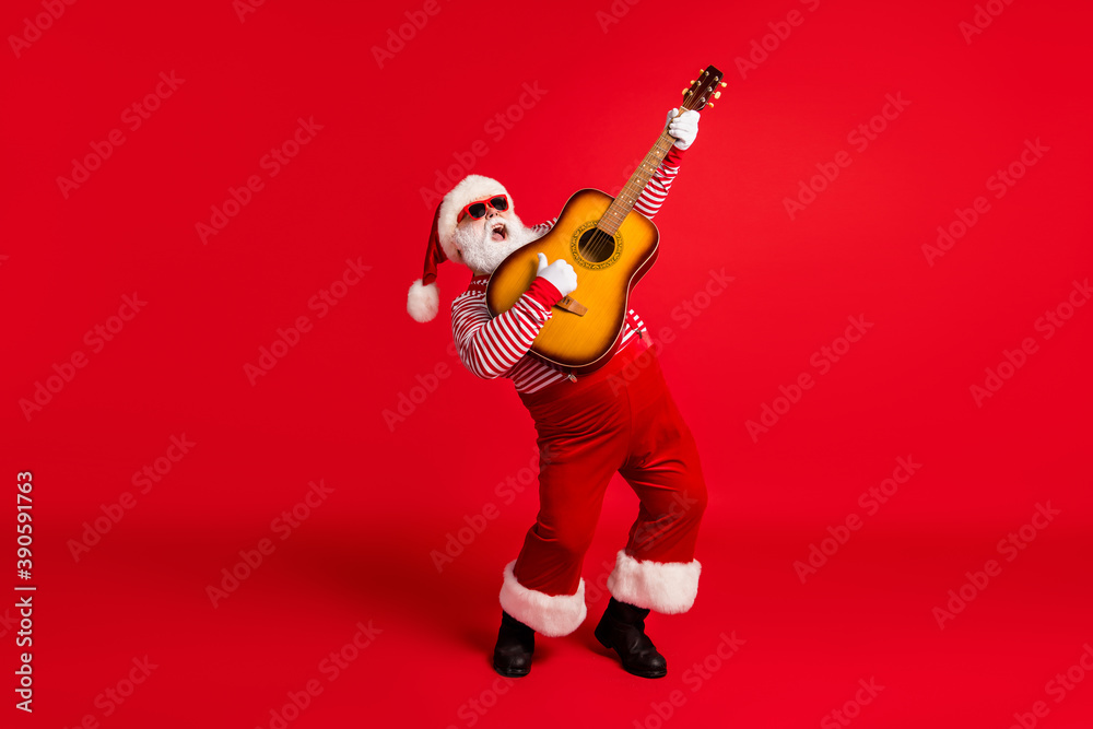 Full length body size view of his he handsome bearded fat overweight Santa grandfather soloist playing guitar having fun vocal talent leisure isolated bright vivid shine vibrant red color background Full length body size view of his he handsome bearded fat overweight Santa grandfather soloist playing guitar having fun vocal talent leisure isolated bright vivid shine vibrant red color background