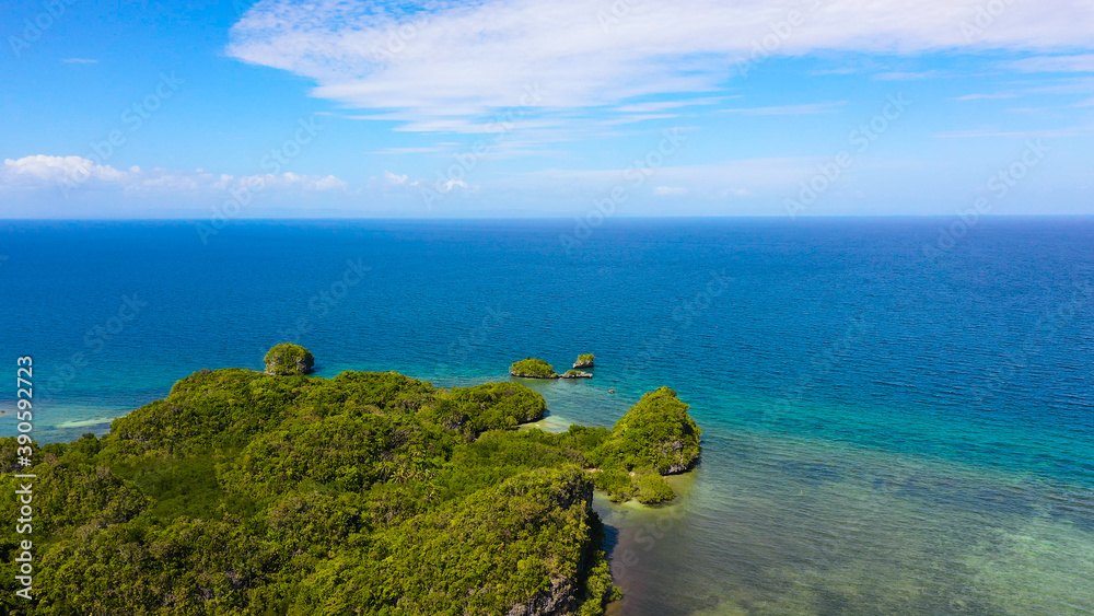Aerial view of the mountains covered with jungle, blue sea and sky with clouds. Bohol,Philippines. Aerial view of the mountains covered with jungle, blue sea and sky with clouds. Bohol,Philippines.