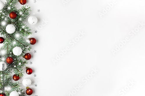 Christmas background with Xmas toys on a white wooden table. New Year card. Copy space, flat lay