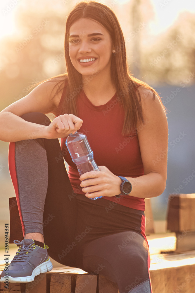 Modern young woman making pause after jogging / exercise. Modern young woman making pause after jogging / exercise.
