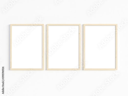 A mockup of three thin A4 wooden frames with portrait orientation. 3D illustration.