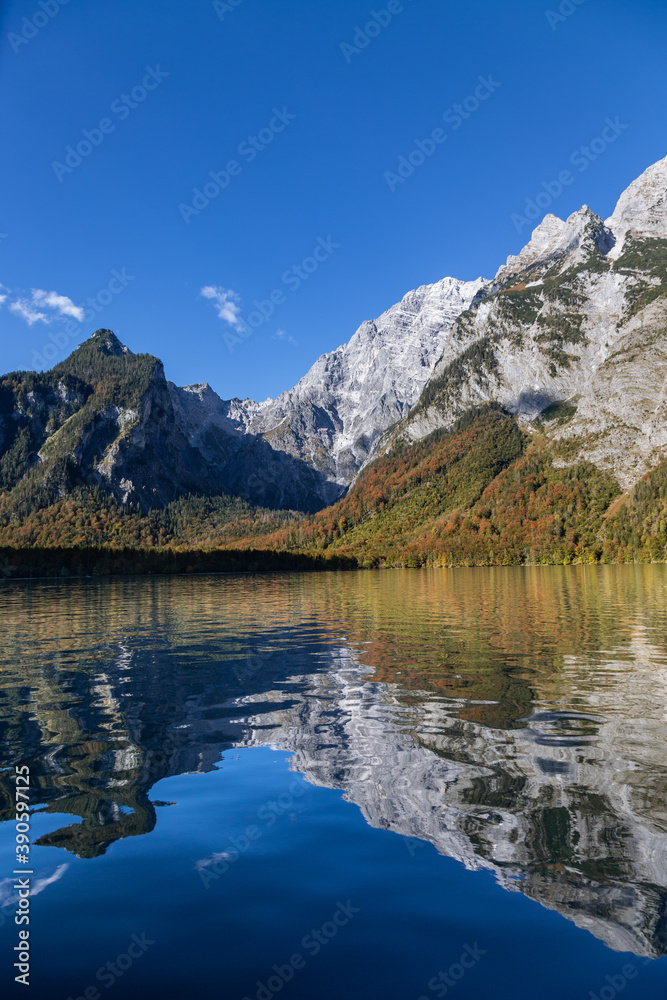 Mountains reflecting in the clear waters of the Koenigssee in Berchtesgadener Land, Bavaria, Germany.
