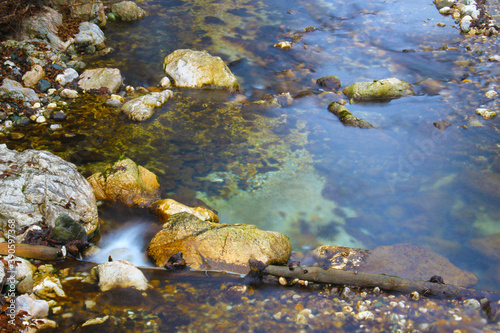 Water splash on a river with small cascades. © Primus_1