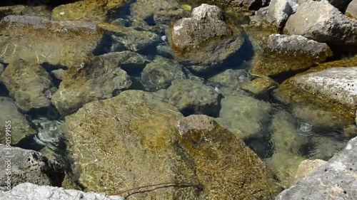 Sea water ripples easily between large stones