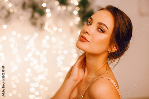 Girl in evening dress posing in the New Year's studio