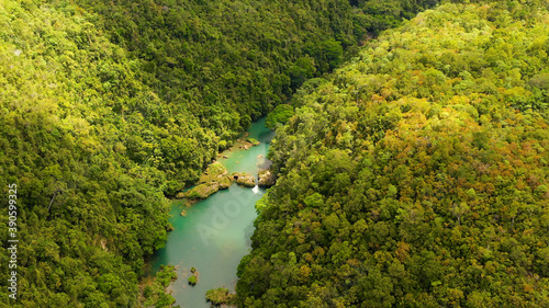 River and tropical rainforest in summer day. The drone is flying on the river. Aerial landscape. Bohol  Philippines.