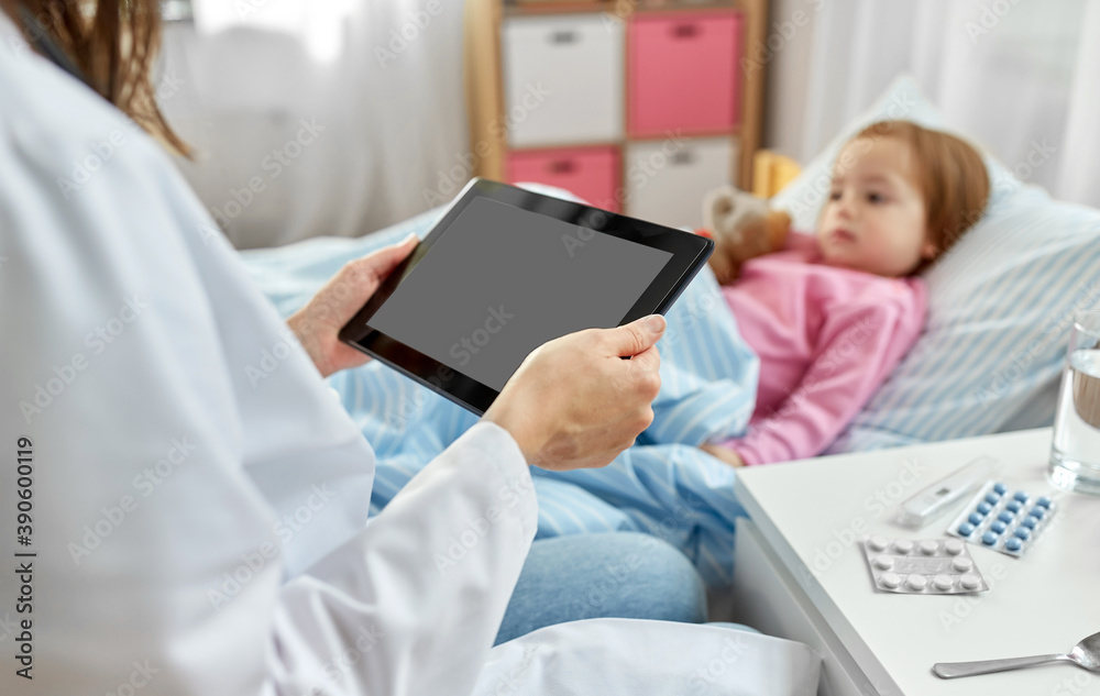 Fototapeta premium healthcare, medicine and people concept - close up of doctor with tablet pc computer and little sick girl lying in bed at home