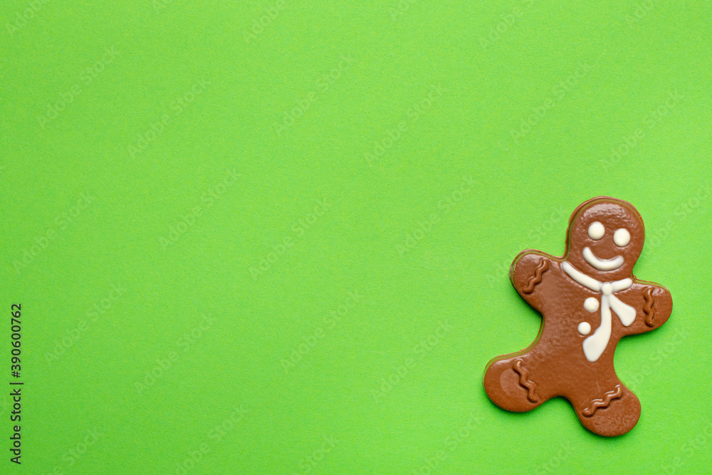 Chocolate figurine of a gingerbread man on a green background new year and Christmas holidays with copyspace