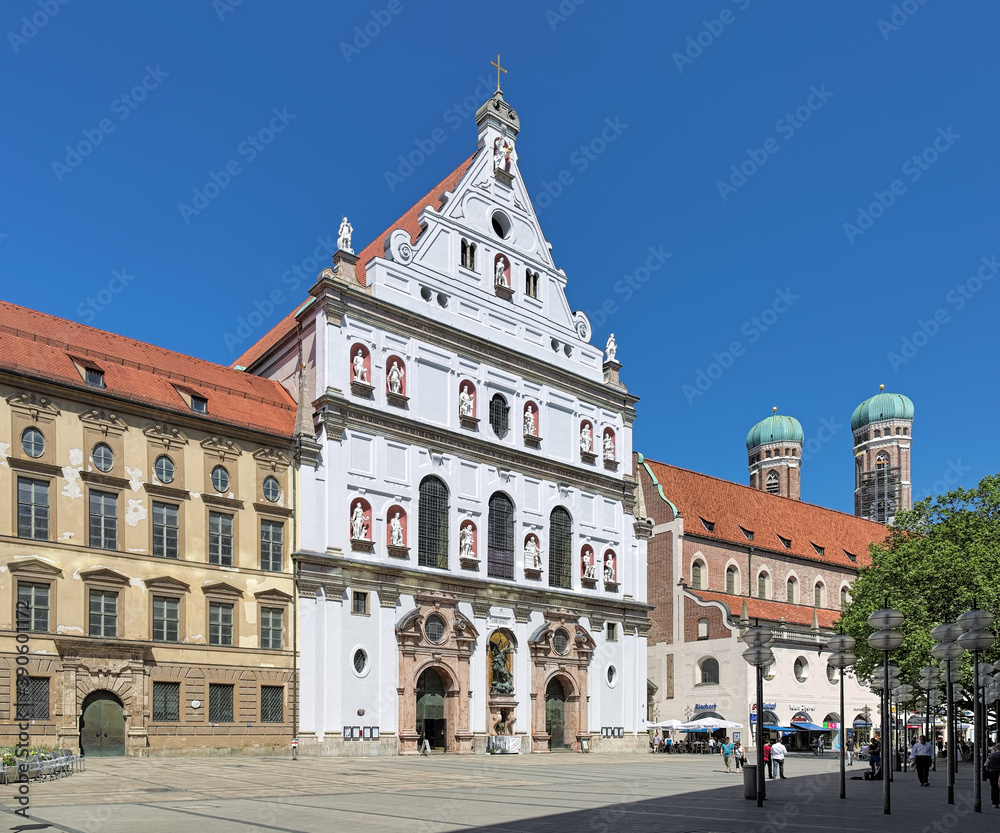 Facade of Michaelskirche (St. Michael's Church) and towers of Frauenkirche (Cathedral of Our Lady) in Munich, Germany.