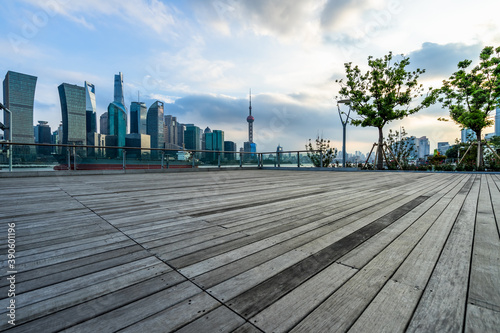 Empty wooden footpath front of shanghai city skyline