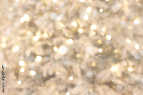 Christmas background with Snow-covered Christmas tree branches and blurred lights on back. Disfocus image.