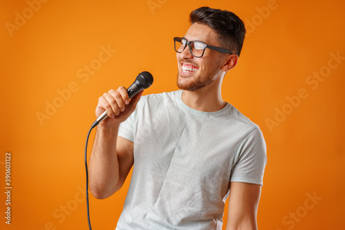 Tablou pe pânză Hispanic young handsome man singing with joy in microphone