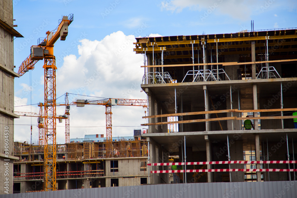 Construction of apartment buildings in a new neighborhood with tower cranes .Horizontally.