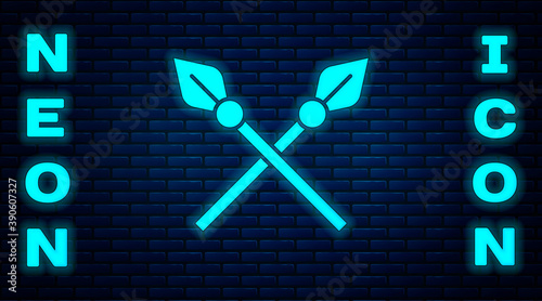 Glowing neon Crossed medieval spears icon isolated on brick wall background. Medieval weapon. Vector.