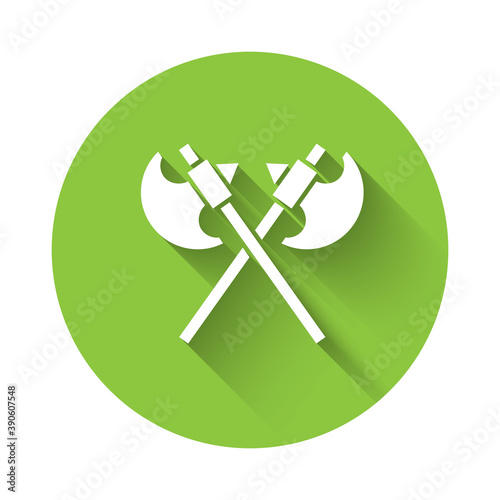 White Crossed medieval axes icon isolated with long shadow. Battle axe, executioner axe. Medieval weapon. Green circle button. Vector.