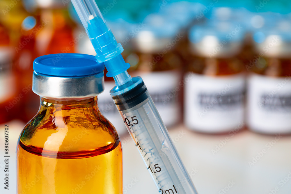 Medical vial with medication and syringe close up
