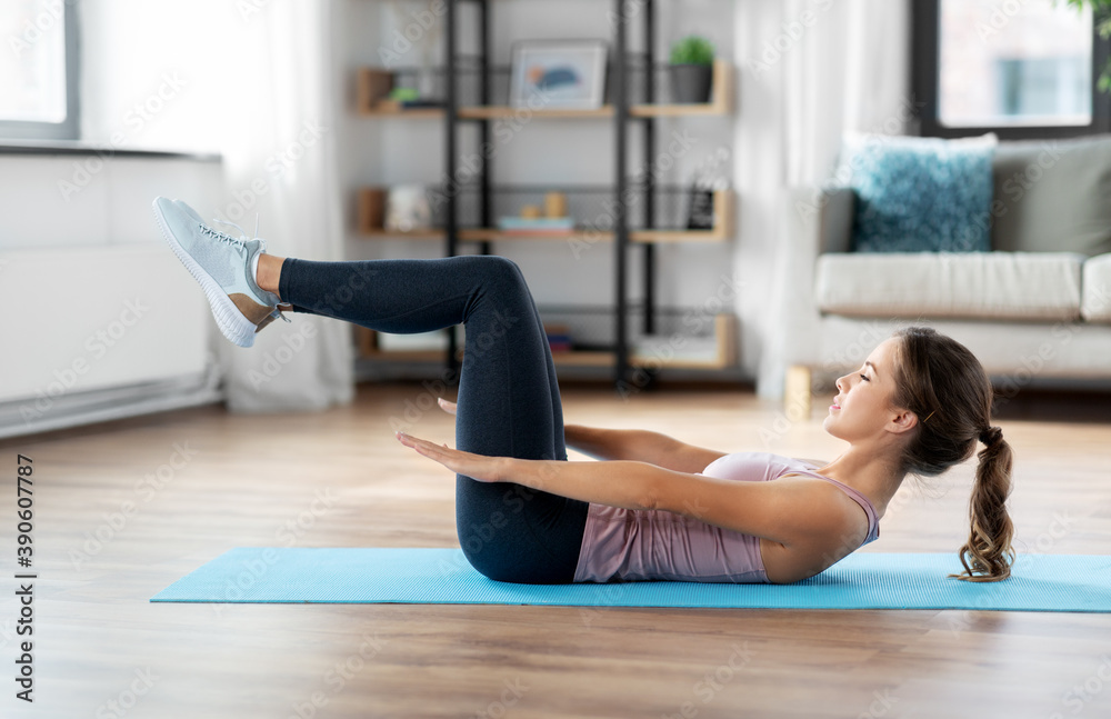 sport, fitness and people concept - happy woman exercising lying on mat at home sport, fitness and people concept - happy woman exercising lying on mat at home