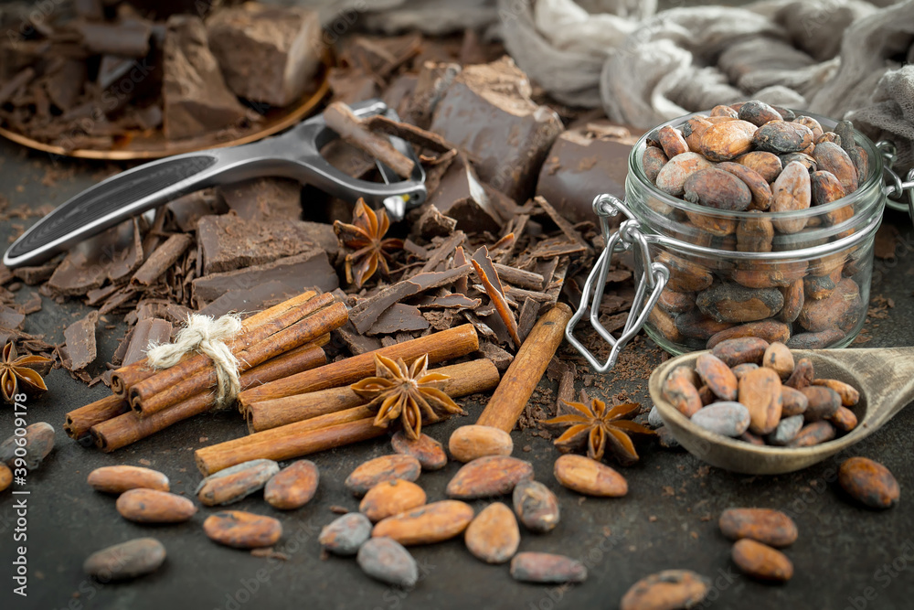 Pieces of dark chocolate and cocoa beans in composition on old background Pieces of dark chocolate and cocoa beans in composition on old background