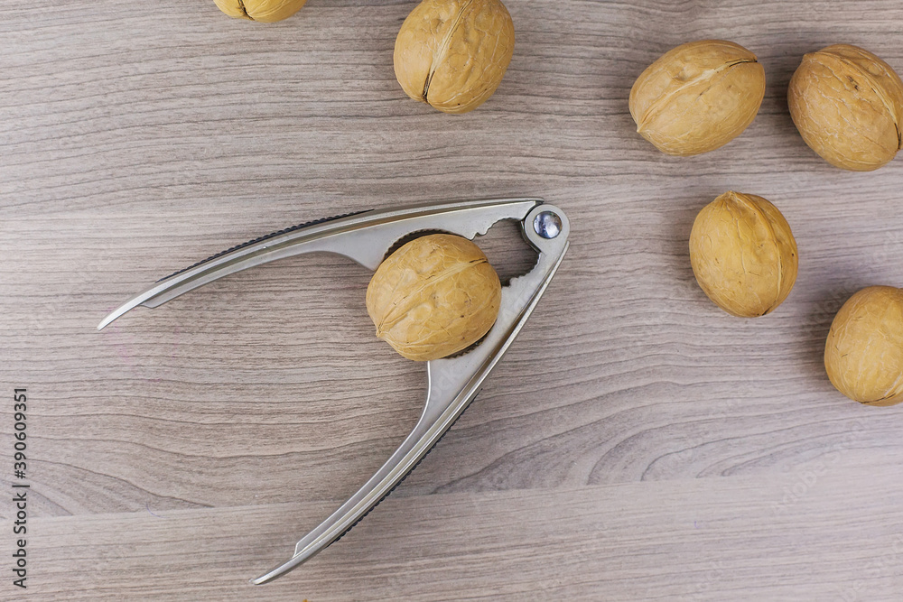 Whole walnuts in shell in bowl, walnut kernels. Top view. Whole walnuts in shell in bowl, walnut kernels. Top view.