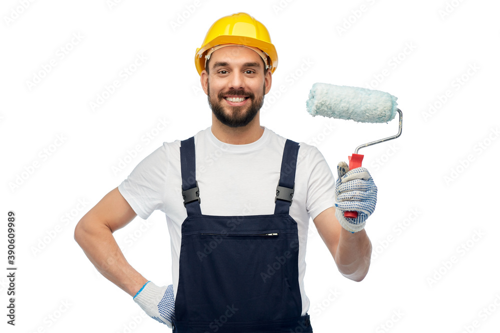 profession, construction and building - happy smiling male worker or builder in yellow helmet and overall with paint roller over white background