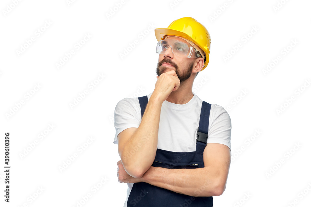 profession, construction and building - thinking male worker or builder in yellow helmet and goggles over white background