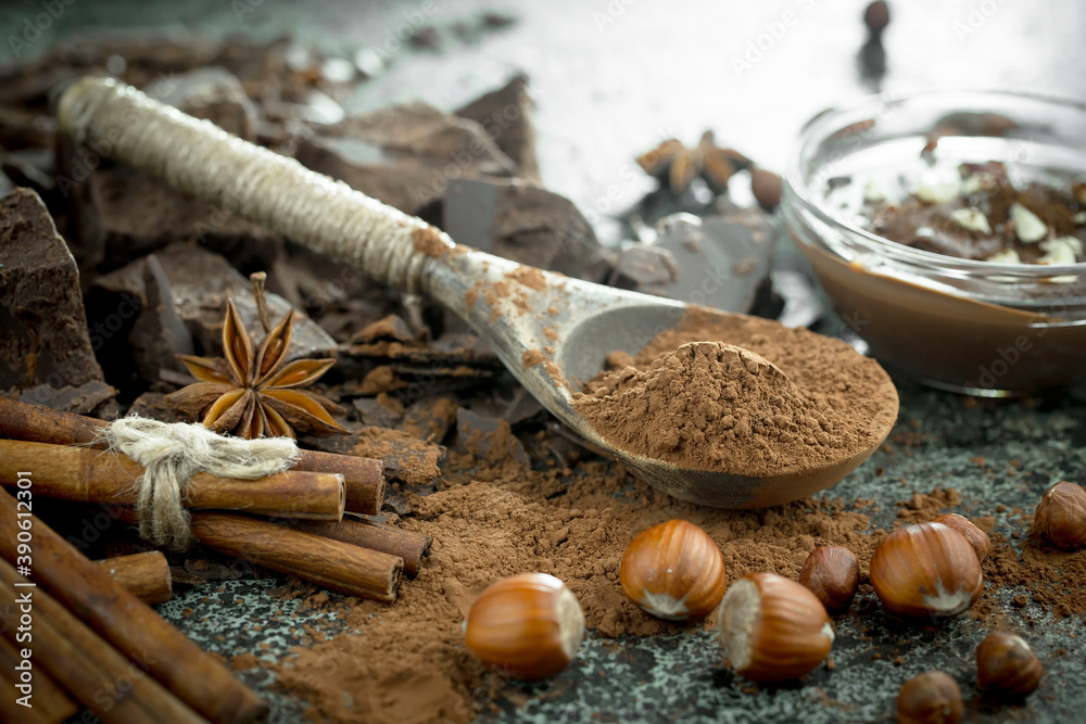 Hot chocolate on an old background in a composition with cocoa beans and nuts. Hot chocolate on an old background in a composition with cocoa beans and nuts.