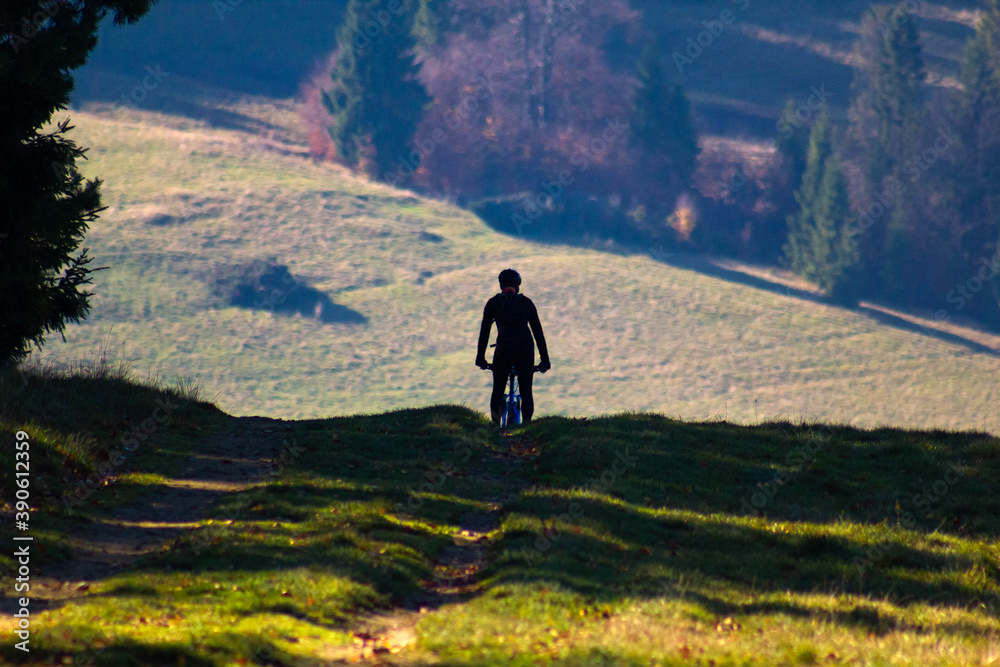 Silhouette of cyclist in mountains in autumn Silhouette of cyclist in mountains in autumn