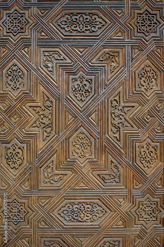 wooden door in the alhambra decorated with mosaic