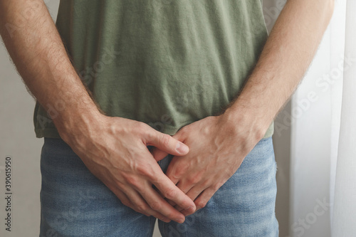 Konstfotografi Man cover his groin by hands. Men's health. Urology problems male