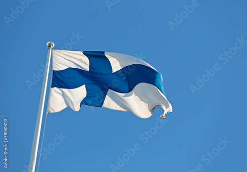 Finlands blue and white flag waving against blue sky Fototapet