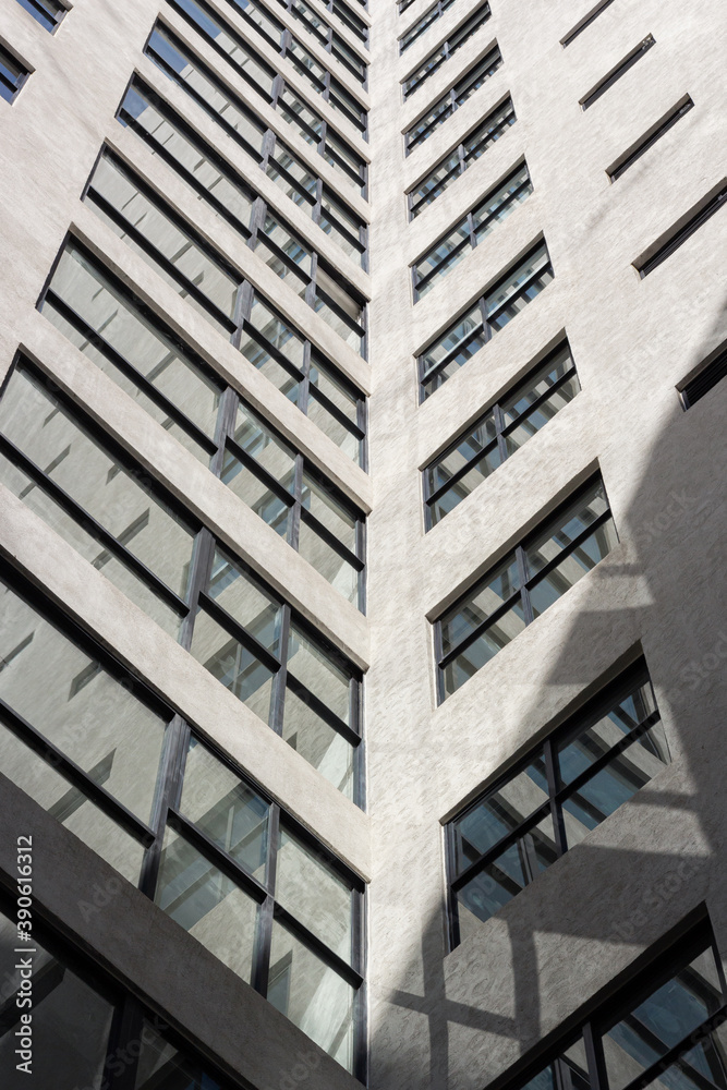 white building with windows and shadows in architecture, apartment.