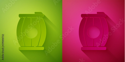 Paper cut Gun powder barrel icon isolated on green and pink background. TNT dynamite wooden old barrel. Paper art style. Vector.