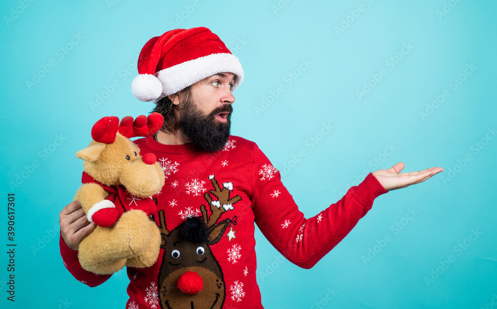 Find presents online. merry christmas to you. xmas shopping time. prepare gifts and presents. reindeer toy. happy bearded mature man in santa claus hat. new year party. celebrate winter holidays