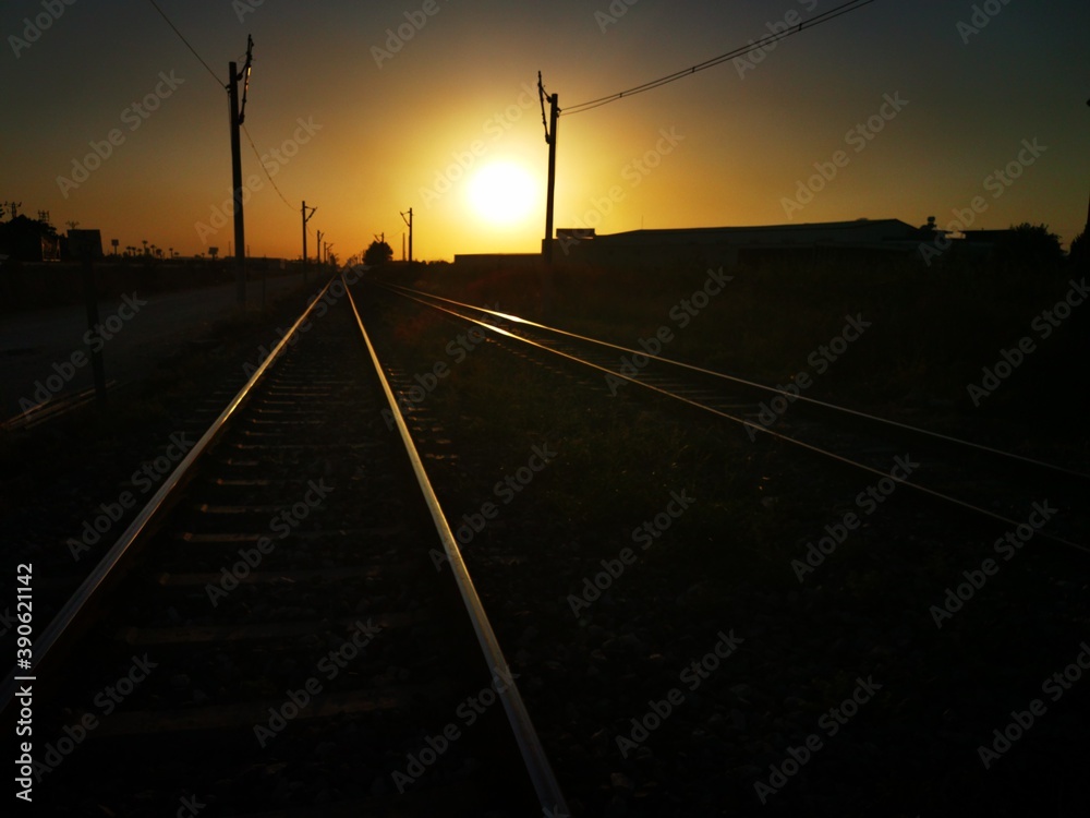 shiny railway tracks glowing in the golden light of sunset showing excellent perspective Tarsus Turkey