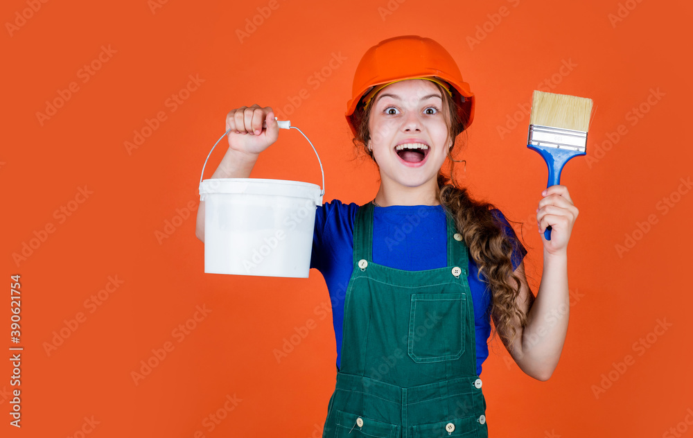 Ready to work. kid wear helmet on construction site. teen girl painter with painting bucket and brush. child on repairing work. concept of renovation in workshop. busy professional carpenter Ready to work. kid wear helmet on construction site. teen girl painter with painting bucket and brush. child on repairing work. concept of renovation in workshop. busy professional carpenter