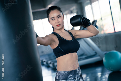 Boxer women punching bag at a boxing studio © themorningglory
