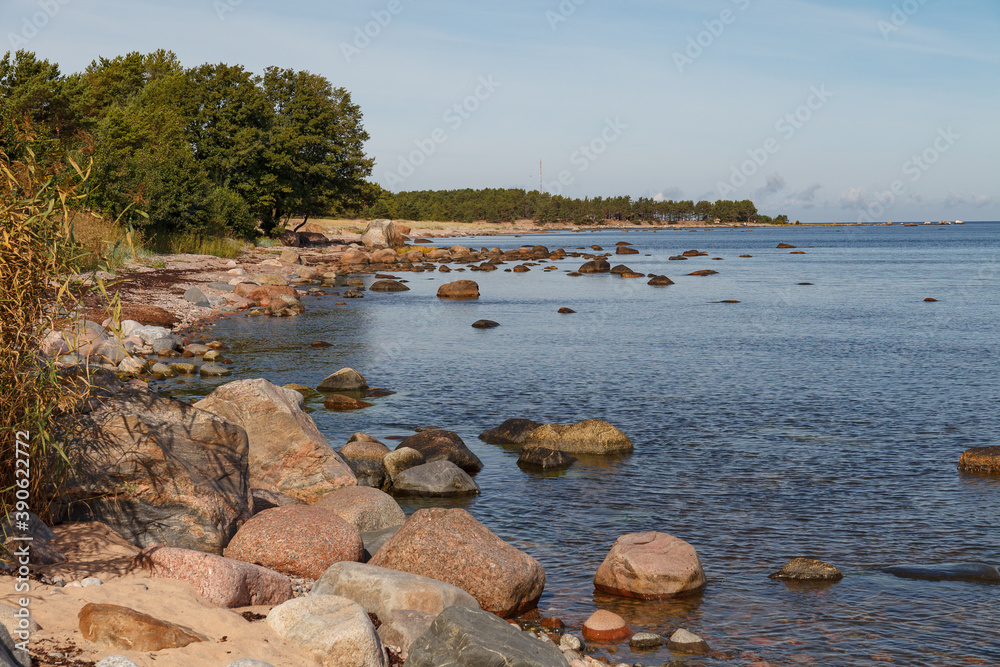 Granite stones on the beach of the Gulf of Finland in bright summer day