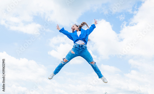 happy energetic kid feeling free and jumping high, success