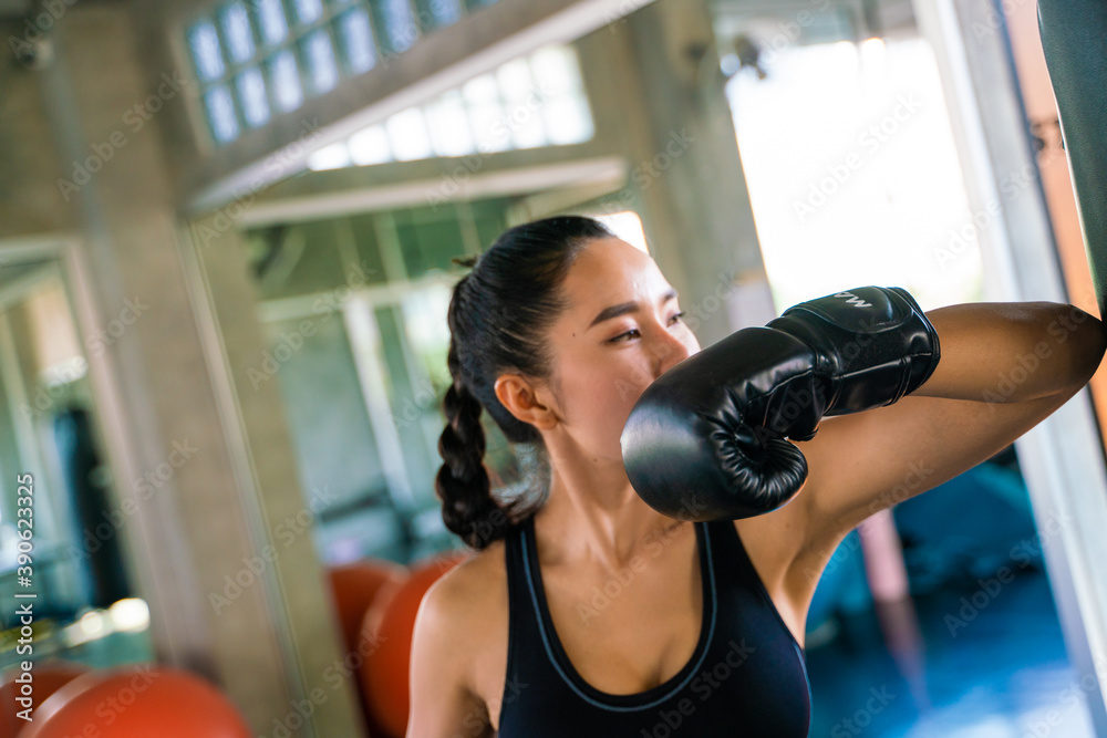 Boxer women punching bag at a boxing studio